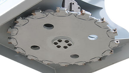 Baumalight DPH series PTO tree cutter with three-point hitch mounted on a New Holland tractor on white background