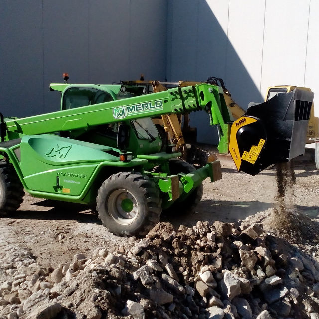 Merlo MB L140 telehandler operating on a construction site with rocks and gravel.
