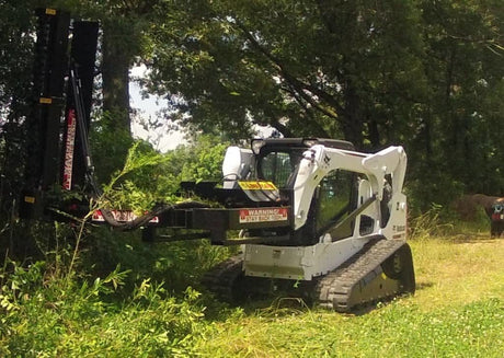 Limb Beaver LB6SS brush cutter mounted on a skid steer clearing thick brush and vegetation