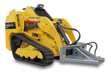 A yellow Baumalight tree puller attachment for mini skid steers, featuring a hydraulic jaw and a cylindrical pulling mechanism.
