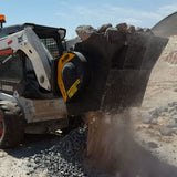 Bobcat-MB-L120_Bobcat loader with a large attachment clearing debris on a construction site.