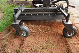 CID Multi-Purpose Power Rake for Mini Skid Steers | Garden tiller on a patch of soil with grass in the background