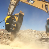 Caterpillar BF150.10 Excavator with a large bucket in a construction site against a clear blue sky.