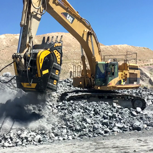 Caterpillar BF150.10 working on a rocky terrain with clear blue sky