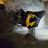 Caterpillar MB-L200, in use on a concrete surface.
