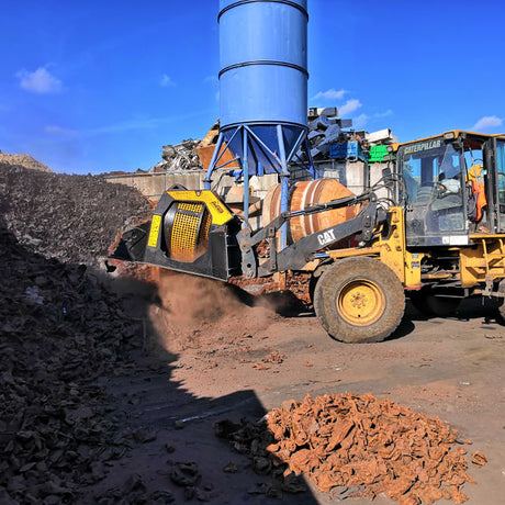 Caterpillar MB-LS170 vehicle operating on a site with a blue silo in the background