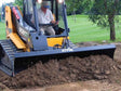 Paladin 6-Way Dozer Blade for skid steers with hydraulic angle and tilt control for precision grading and material pushing