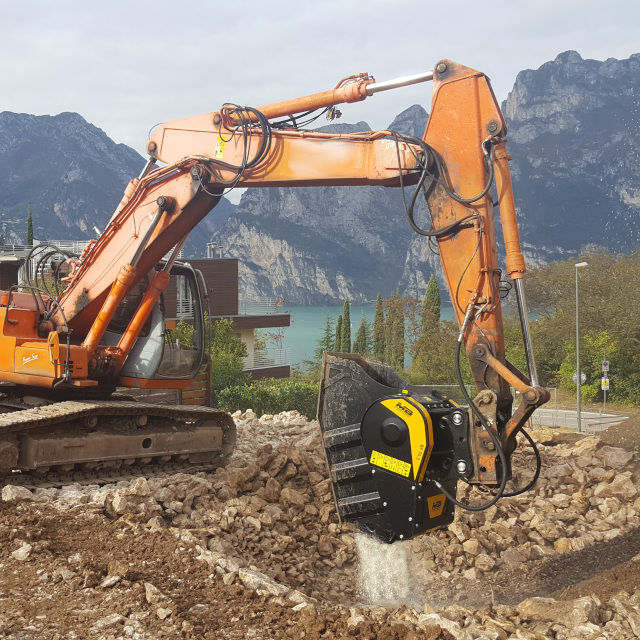 Hitachi-EX235A Excavator operating on a construction site with mountains and water in the background