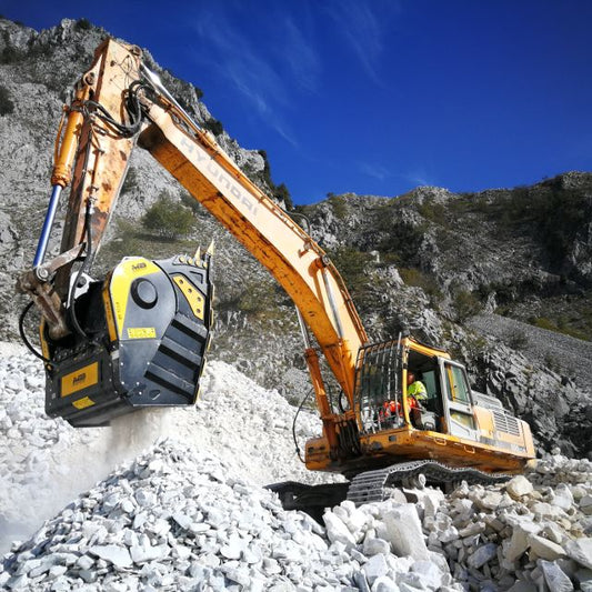 Hyundai R500LC-7 Excavator operating on a rocky terrain with mountains in the background