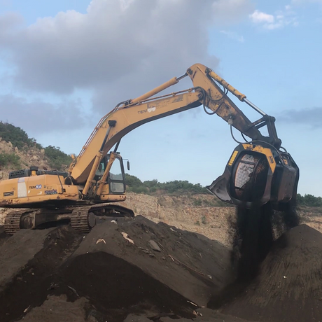 Komatsu-PC300 excavator digging at a construction site with a clear sky in the background