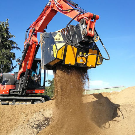 Kubota-KX080 Excavator with a bucket digging into the ground against a blue sky.