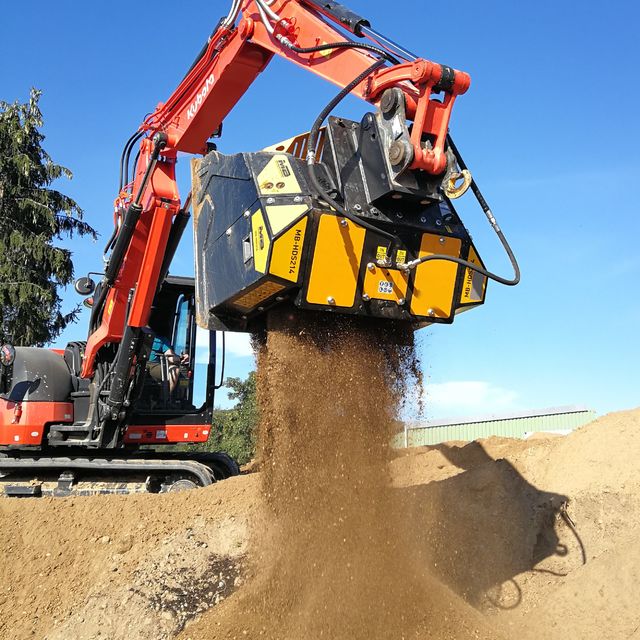 Kubota-KX080 Excavator with a bucket digging into the ground against a blue sky.