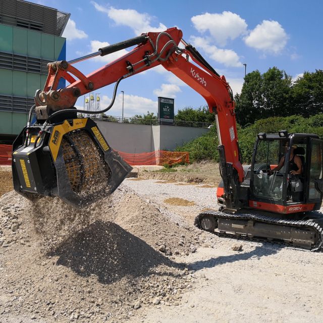 Kubota-KX080 excavator working on a construction site with a clear sky in the background