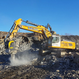 Liebherr-R956 excavator operating on a construction site with a clear blue sky