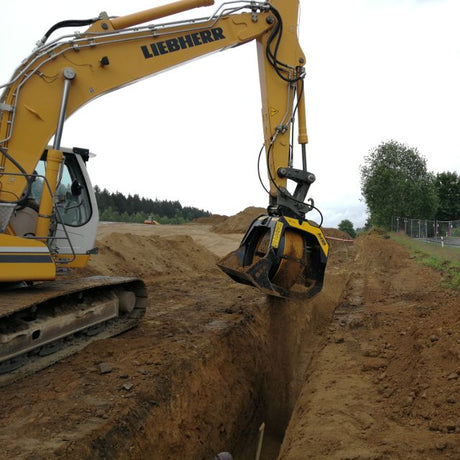 Liebherr excavator digging into the ground on a construction site.