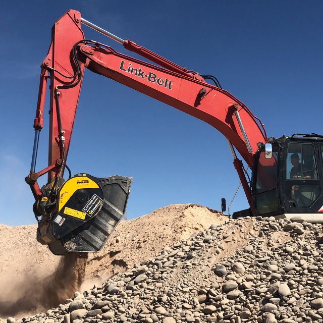 Link Belt-210 X2 Excavator operating on a construction site against a blue sky.