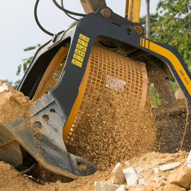 MB-S23 Excavator bucket filled with dirt on a construction site