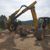 MenziMuck MB-L140 loader on a construction site with trees in the background