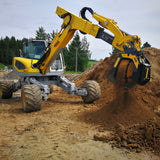 MenziMuck MB-S10 excavator at a construction site with dirt and trees in the background