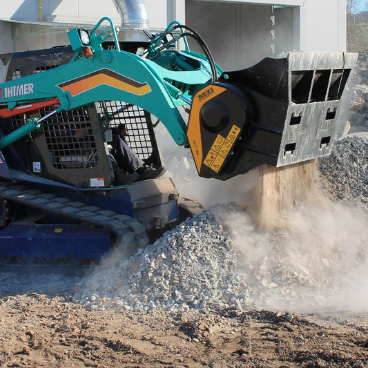Mulchtech MB-L160 shoveling gravel or rubble.