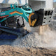 Mulchtech MB-L160 shoveling gravel or rubble.