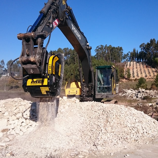 Volvo BF60 Excavator operating on a construction site with trees in the background