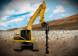 Yellow excavator with a drill attachment on a construction site